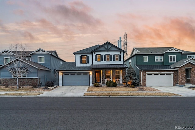 view of front of house with driveway, a standing seam roof, a porch, and metal roof