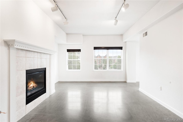 1780 N Washington St Unit 305, Denver, CO 80203 - unfurnished living room featuring track lighting, a tile fireplace, and baseboards