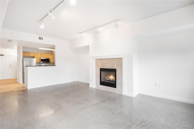 1780 N Washington St Unit 305, Denver, CO 80203 - unfurnished living room with track lighting, a fireplace, and finished concrete flooring