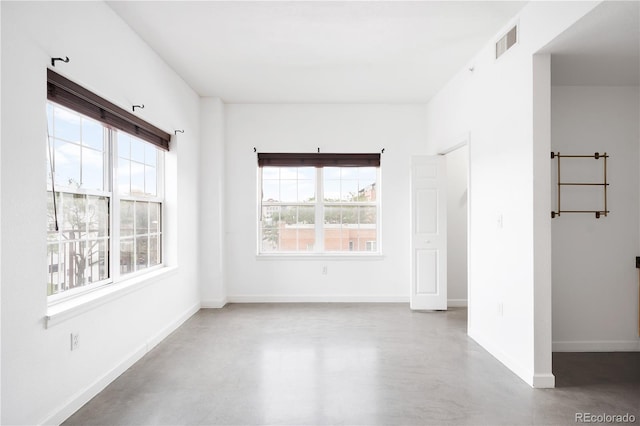 1780 N Washington St Unit 305, Denver, CO 80203 - spare room featuring concrete flooring, healthy amount of natural light, and baseboards