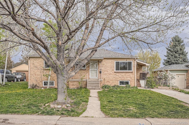 view of front of property with a garage, roof with shingles, a front lawn, and brick siding