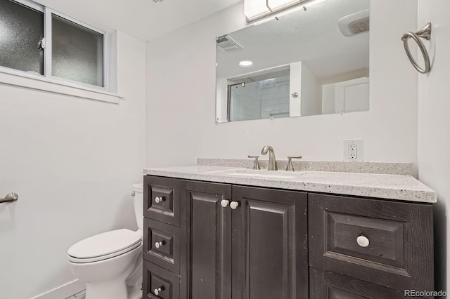 full bathroom with walk in shower, vanity, toilet, baseboards, and visible vents