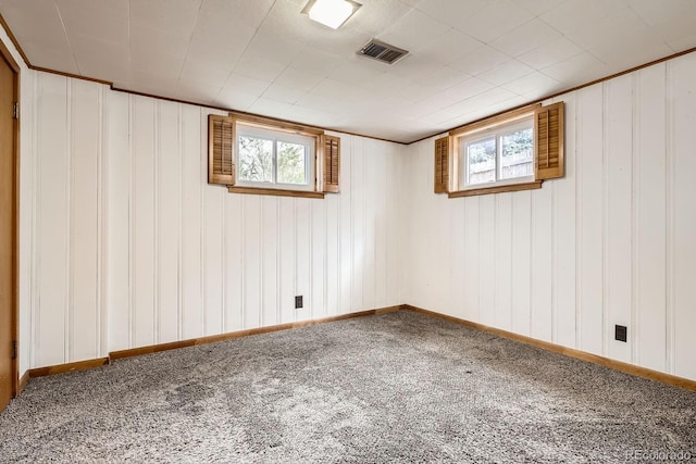 spare room with plenty of natural light, carpet flooring, and visible vents
