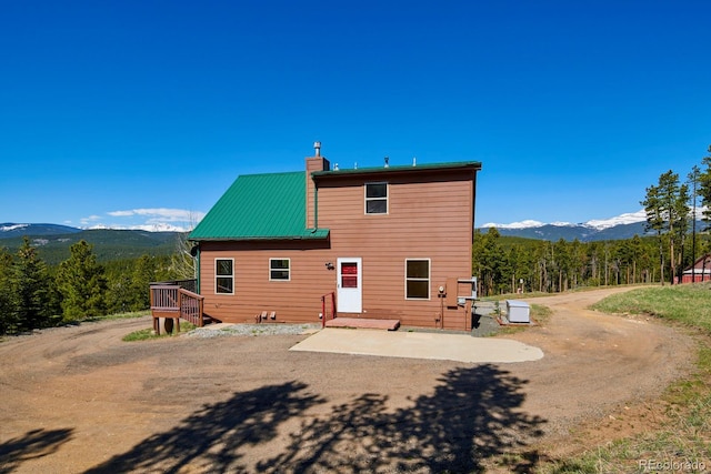 rear view of house with a mountain view