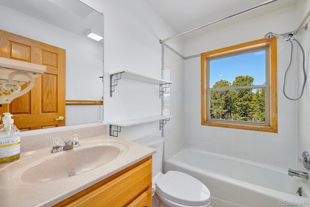 full bathroom featuring tiled shower / bath, vanity, and toilet