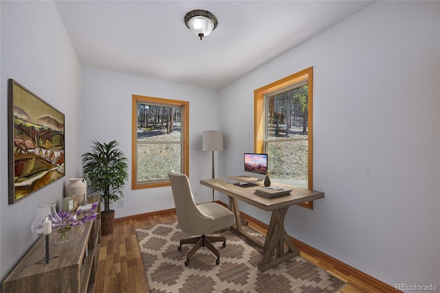 office with a wealth of natural light and wood-type flooring