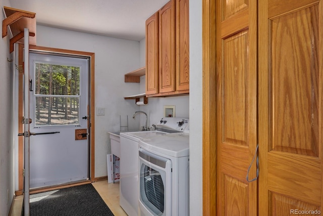 laundry area featuring washer and dryer and cabinets