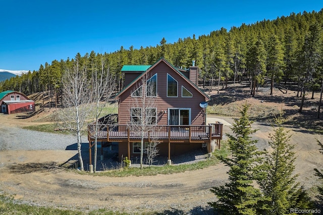 rear view of property with a wooden deck