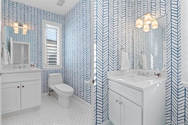 full bathroom with toilet, a sink, visible vents, tile patterned floors, and wallpapered walls