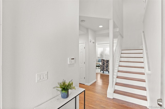 interior space with wood finished floors and baseboards