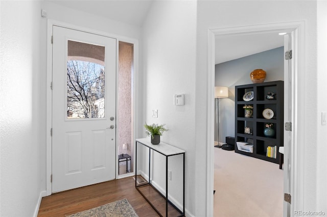 entryway featuring dark wood-type flooring and baseboards