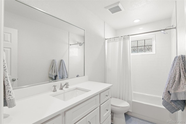 full bath featuring toilet, shower / bath combo, visible vents, and vanity