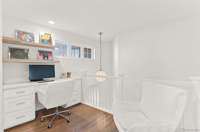 office area with wainscoting, recessed lighting, built in desk, and wood finished floors