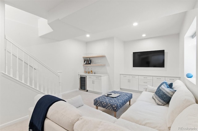 living area featuring light carpet, beverage cooler, a dry bar, and stairs