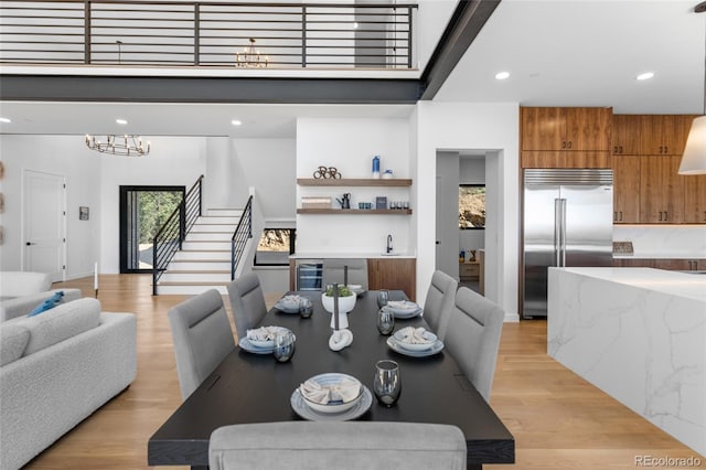 13415 S Resort Dr, Conifer, CO 80433 - dining space featuring stairway, recessed lighting, light wood-style floors, and beverage cooler
