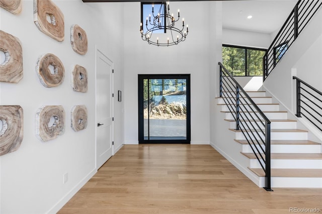 13415 S Resort Dr, Conifer, CO 80433 - foyer featuring a chandelier, light wood-type flooring, stairs, recessed lighting, and a towering ceiling