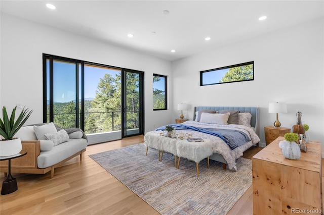 13415 S Resort Dr, Conifer, CO 80433 - bedroom featuring multiple windows, access to exterior, recessed lighting, and light wood-style flooring