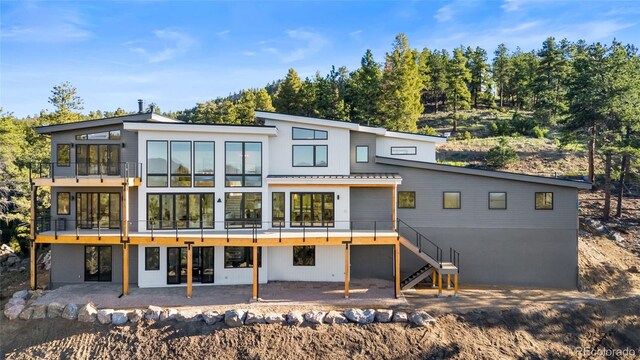 13415 S Resort Dr, Conifer, CO 80433 - rear view of property featuring stairs and a patio