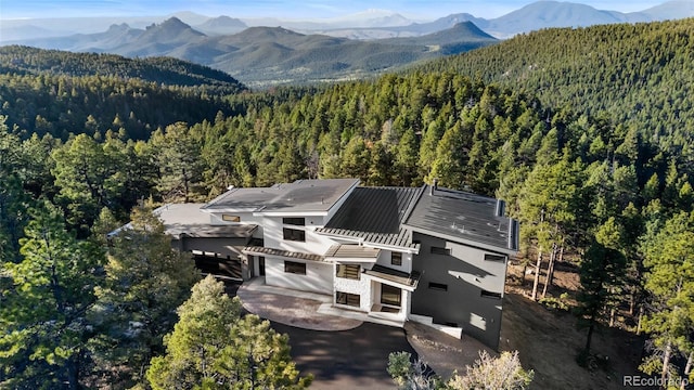 13415 S Resort Dr, Conifer, CO 80433 - view from above of property featuring a heavily wooded area and a mountainous background