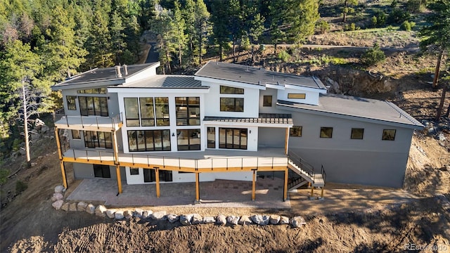 13415 S Resort Dr, Conifer, CO 80433 - back of property featuring a view of trees, a metal roof, and a balcony