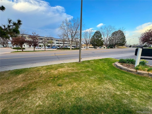 view of road featuring sidewalks and street lights