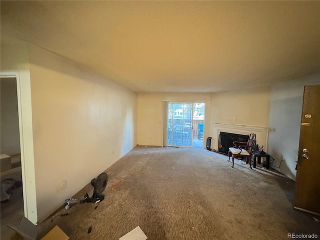 unfurnished living room with a fireplace and carpet floors