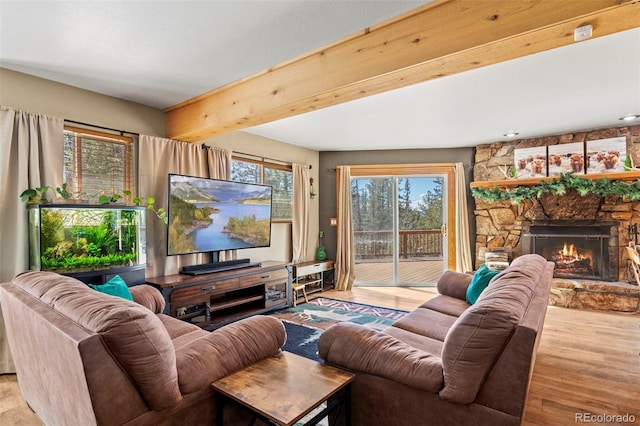 living room with beam ceiling, wood finished floors, and a fireplace