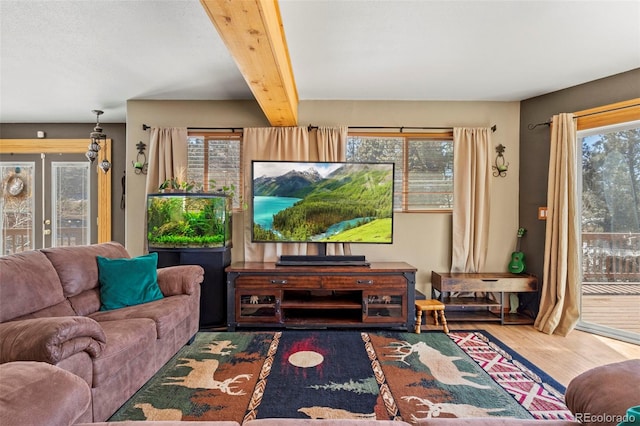 living room with beamed ceiling and wood finished floors