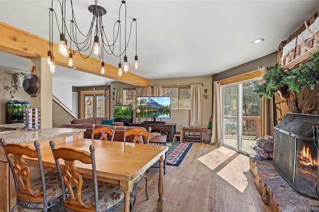 dining area featuring stairway, an inviting chandelier, and wood finished floors