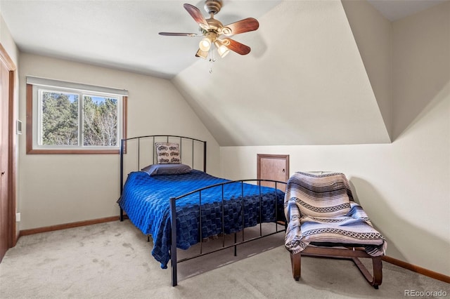 carpeted bedroom featuring lofted ceiling, a ceiling fan, and baseboards