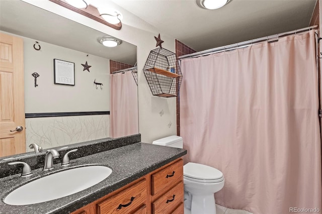 bathroom with toilet and vanity