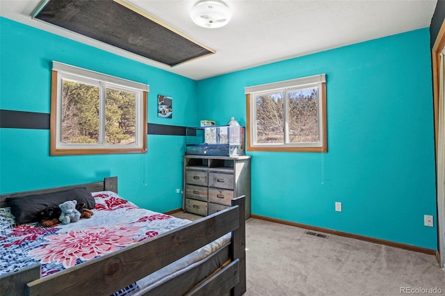 carpeted bedroom featuring baseboards