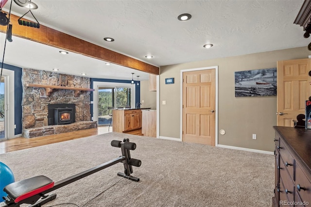 exercise area with recessed lighting, carpet, baseboards, and a textured ceiling