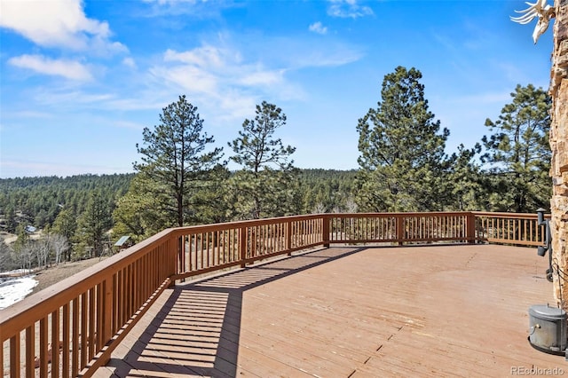 wooden deck featuring a wooded view