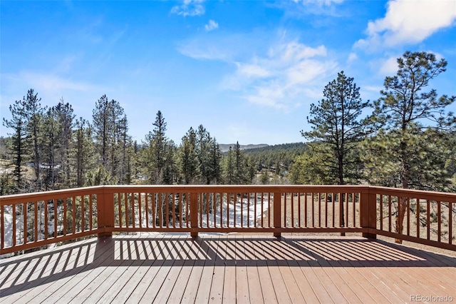 wooden deck featuring a wooded view