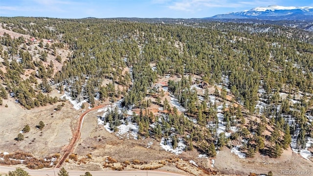 aerial view with a wooded view and a mountain view