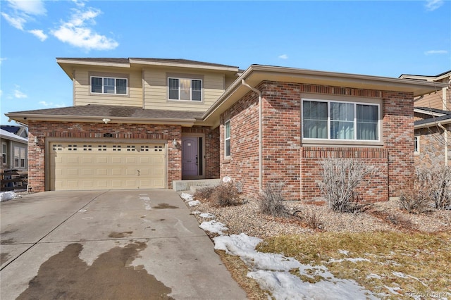 view of front of property with an attached garage, concrete driveway, and brick siding