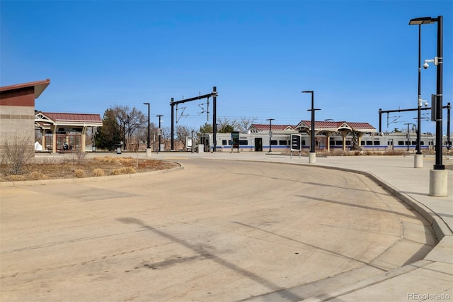 view of street featuring street lighting and curbs