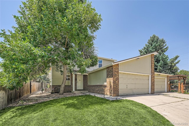 view of front of home featuring a garage and a front lawn