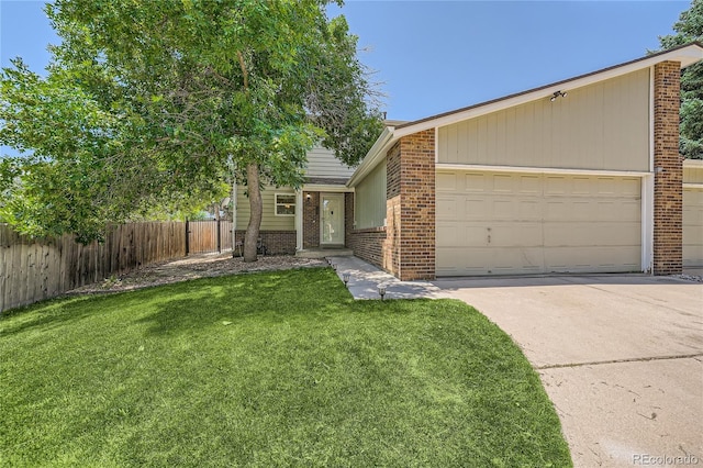 ranch-style house featuring a garage and a front lawn