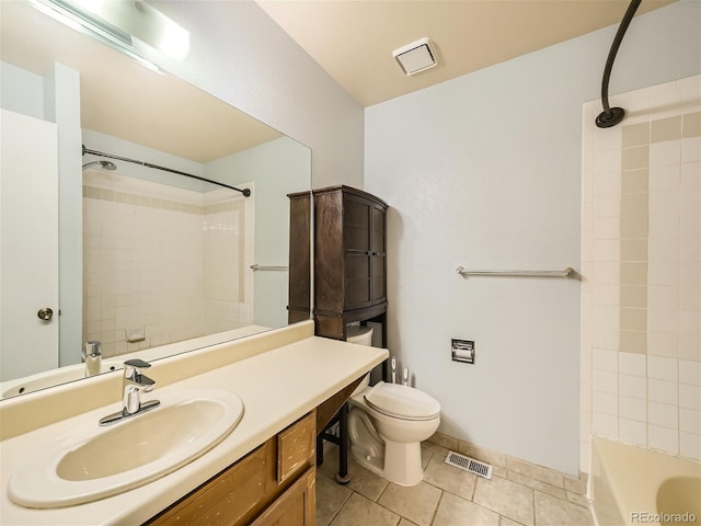 full bathroom featuring tile patterned flooring, vanity, toilet, and tiled shower / bath