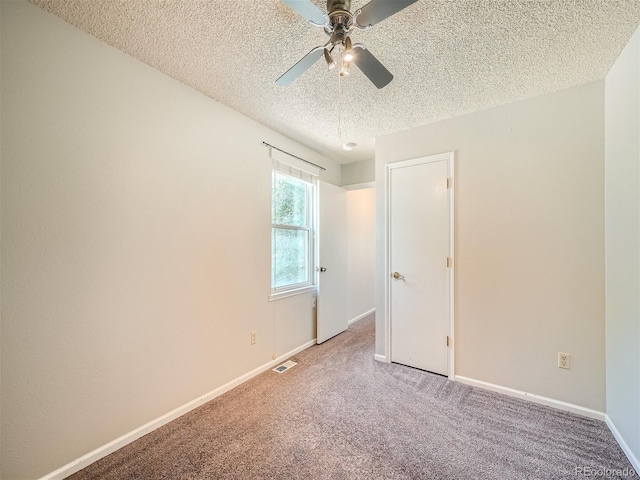 unfurnished bedroom with ceiling fan, a textured ceiling, and carpet floors