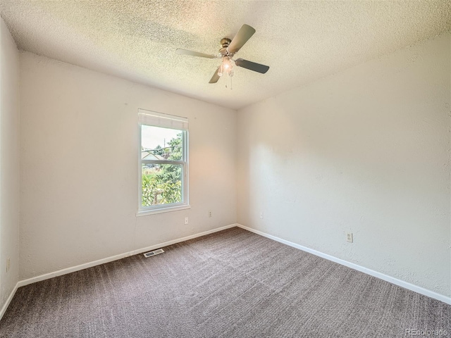 unfurnished room with a textured ceiling, carpet flooring, and ceiling fan