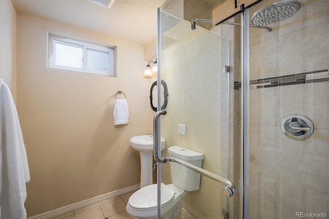full bathroom featuring baseboards, tile patterned floors, a shower stall, and toilet