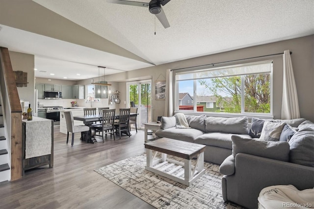 4915 Parsons Way, Castle Rock, CO 80104 - living room featuring a ceiling fan, lofted ceiling, wood finished floors, a textured ceiling, and recessed lighting