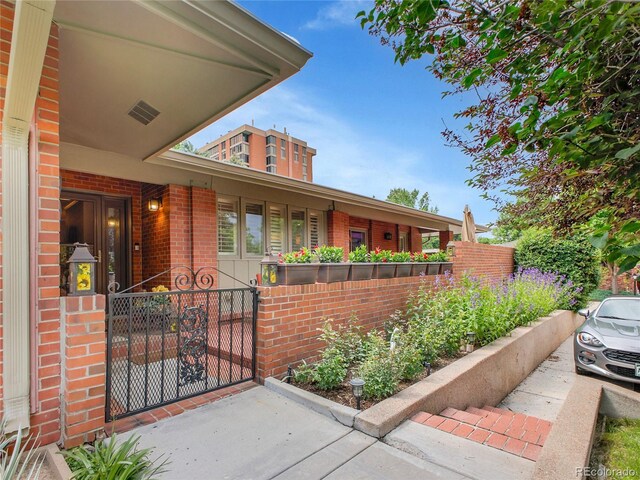 3481 S Race St, Englewood, CO 80113 - view of front facade featuring brick siding and a gate