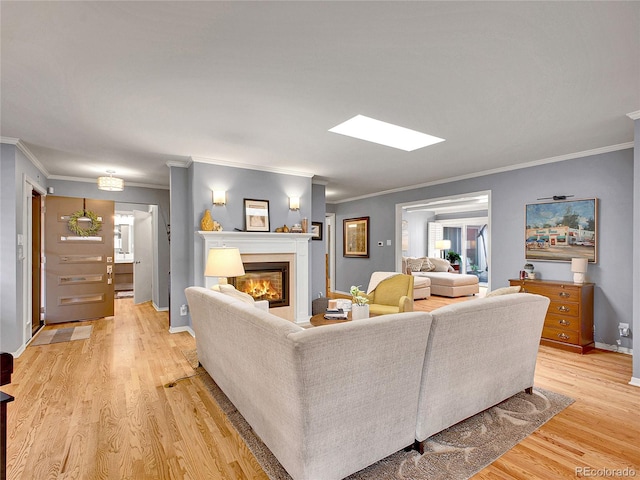 3481 S Race St, Englewood, CO 80113 - living area with a glass covered fireplace, light wood-style floors, ornamental molding, and plenty of natural light