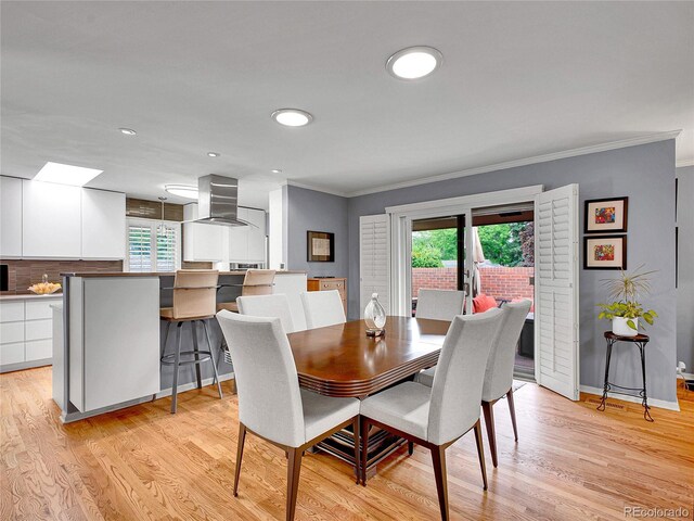 3481 S Race St, Englewood, CO 80113 - dining room with healthy amount of natural light, ornamental molding, light wood-style floors, and recessed lighting