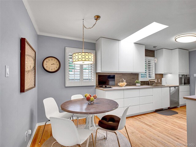 3481 S Race St, Englewood, CO 80113 - dining space with light wood-style floors and ornamental molding