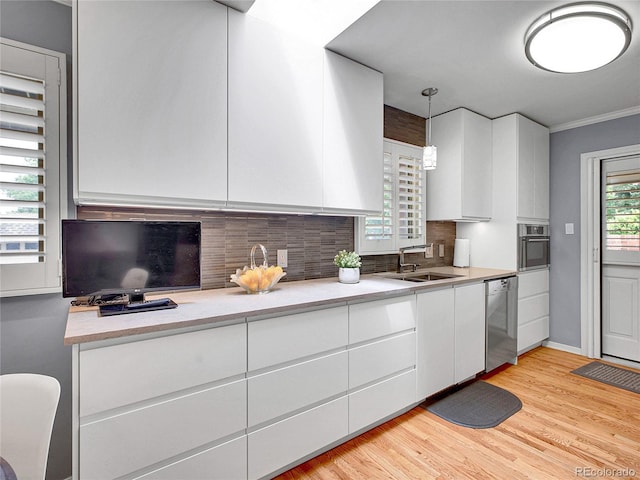 3481 S Race St, Englewood, CO 80113 - kitchen with dishwasher, white cabinets, decorative backsplash, and crown molding